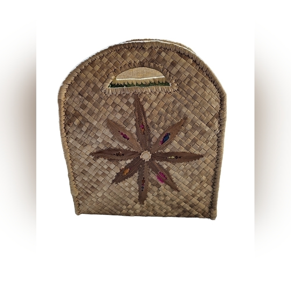 Straw purse with flower design on each side.